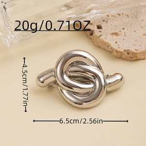 Close-up of a silver minimalist knotted metal hair tie showing texture and 6.5cm dimensions