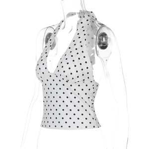 Detail of white halter neck top with black polka dot pattern and tie-back backless design