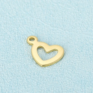 Polished gold stainless steel hollow heart pendant for DIY necklace on light blue background