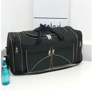 Detail of black travel bag with gold trim, multiple zip pockets and adjustable strap