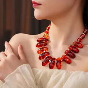 Irregular geometric amber beaded necklace with vintage aesthetic and gold spacers