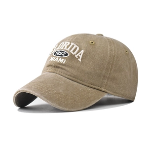 Close-up of white Florida embroidery on washed khaki cotton vintage baseball cap