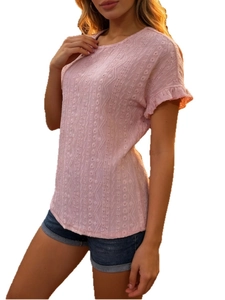 Detailed view of pink short-sleeve top with hollow embroidery and ruffle cuffs