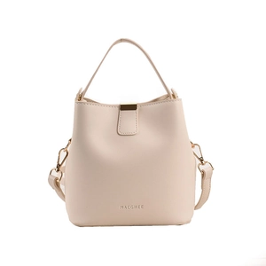 Minimalist beige PU leather bucket bag with top handle and gold hardware on white background