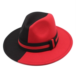 Detail of the two-tone black and red wool fedora hat with a striped decorative band