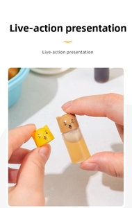 Mini portable condiment bottles with cute cat and dog lids held in hand for scale