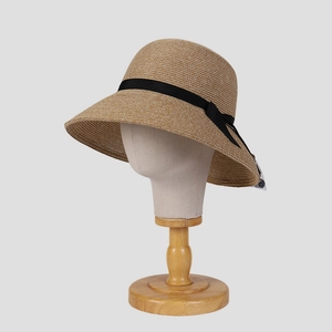 Elegant wide brim straw sun hat for women with black ribbon bow and natural woven texture