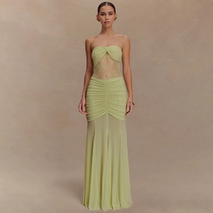 Detail of lime green strapless evening gown with lace inserts and pleated mermaid hem