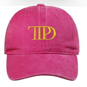 Detail of rose red washed cotton baseball cap with yellow TD letter embroidery