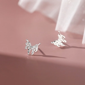 Elegant S999 sterling silver lava butterfly stud earrings with irregular liquid metal texture