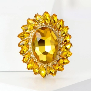 Detail of luxury vintage gold brooch with oval crystal and sparkling rhinestones sunflower