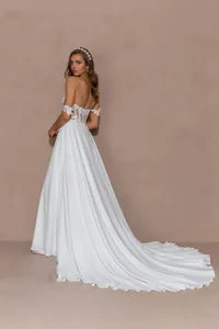 Detailed view of white mermaid wedding dress with sheer lace bodice and long train