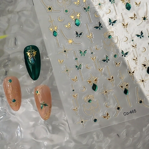 Golden butterfly and emerald gemstone nail stickers with retro celestial star patterns