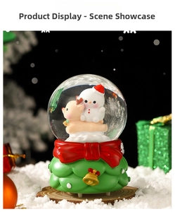 Close-up of a festive Christmas snow globe featuring a snowman, deer, and red bow detail