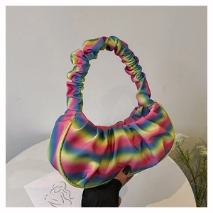 Detail of colorful rainbow gradient pleated cloud bag with scrunchie style handle strap