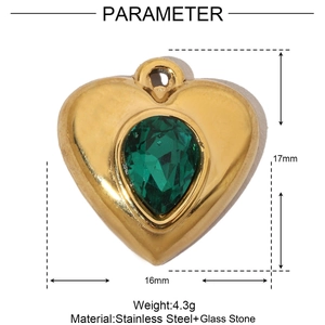 Macro detail of gold heart pendant with green gemstone including size measurements