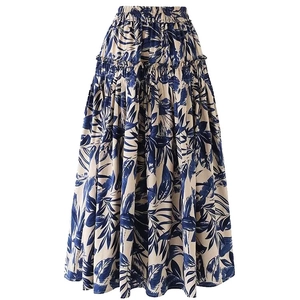 Detail of high-waist tiered skirt with blue tropical leaf prints and elastic waistband