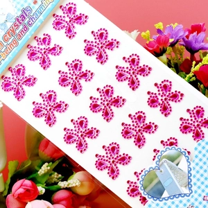 Macro detail of pink acrylic crystal stickers in flower shapes for DIY decoration