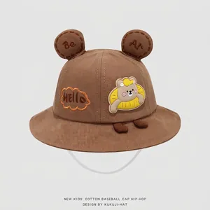 Detailed embroidery of cute bear ears and cotton fabric texture on children's brown bucket hat