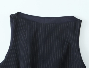 Detailed view of dark navy vertical striped knit fabric and collar stitching