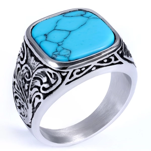Macro detail of men's vintage silver ring with sky blue square turquoise and ornate carvings