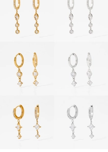 Macro view of six gold and silver stainless steel earrings with sparkling zircon stones