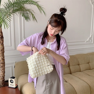Detail of white puff cloud canvas cosmetic bag with 3D texture and Bozakka label