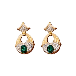 Vintage gold earrings with emerald green gemstones and sparkling diamond accents