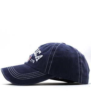 Detailed close-up of navy washed cotton baseball cap with USA 1776 3D embroidery and stitching