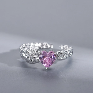 Macro view of silver irregular ring featuring a pink heart-shaped zircon gemstone