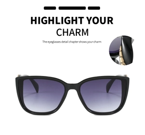 Detail of oversized black sunglasses with purple gradient lenses and gold metal accents