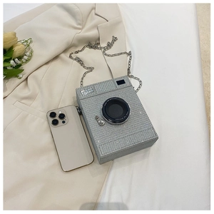 Close-up of sparkling silver rhinestone camera shaped bag with elegant metal chain strap