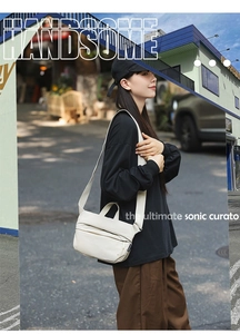 Street style view of cream minimalist crossbody bag with textured fabric and wide strap