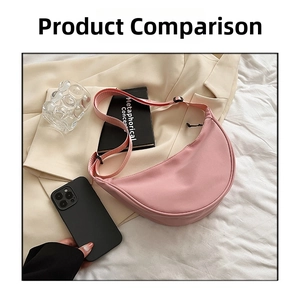 Pink nylon crescent crossbody bag size comparison with a black smartphone on a beige suit