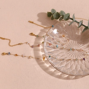 Detail of 18K gold plated stainless steel necklaces with natural colorful crushed stones