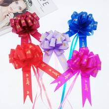 Close-up of matte metallic gift bows with gold hearts and Love text for gift wrapping