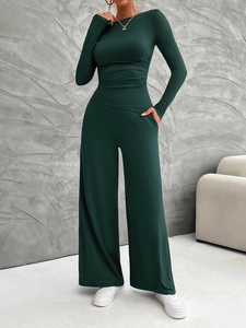 Detail of dark green Y2K long sleeve slim fit top and high waist wide leg pants set
