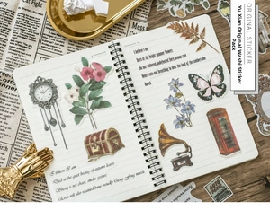 Macro detail of vintage floral stickers with antique butterfly and clock designs