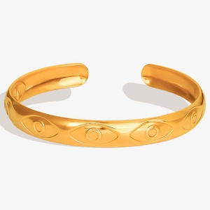 Close-up of 18K gold plated stainless steel evil eye bangle with embossed textures