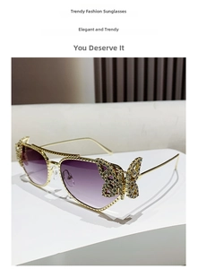 Detailed view of luxury gold sunglasses with rhinestone butterflies and purple lenses