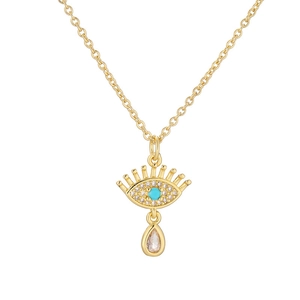 Collier en or avec œil protecteur, pierre turquoise et cristaux sur fond blanc