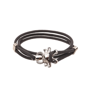 Detailed close-up of a black braided rope bracelet with a silver octopus shaped metal clasp