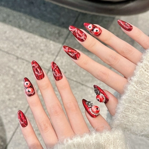 Gothic stiletto press-on nails with dark red gems and silver metallic snake skin texture
