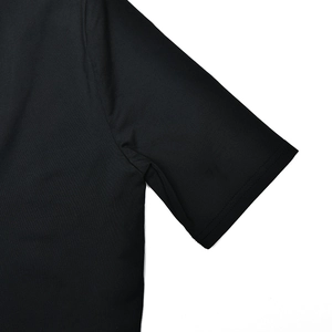 Detailed macro view of the black short sleeve cuff and ribbed fabric texture on bodysuit