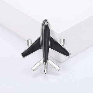 Minimalist silver and black enamel airplane brooch pin with polished metal finish