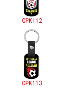 Close-up of leather soccer keychains with Game Changer and Set Goals motivational quotes