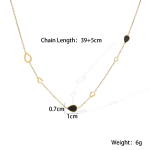 Macro shot of gold plated necklace with black teardrop charms and chain length details