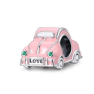 Macro view of pink enamel car charm with green zircons and LOVE engraving in silver