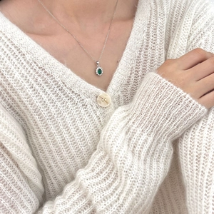 Exquisite 925 sterling silver necklace with oval green zircon halo pendant on a model