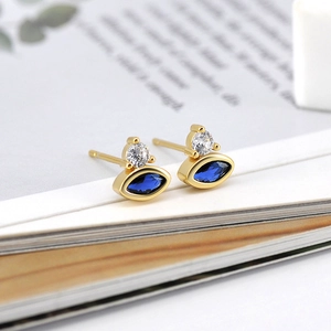 Elegant gold marquise-cut sapphire blue stud earrings with tiny clear accents